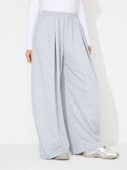 Light gray pleated drape palazzo trousers with a wide leg and elastic waistband.