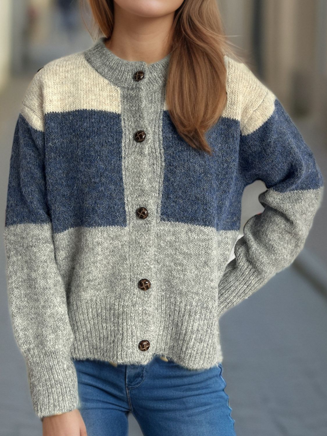Colorblock crewneck button-down cardigan in acrylic with blue, gray, and cream panels.
