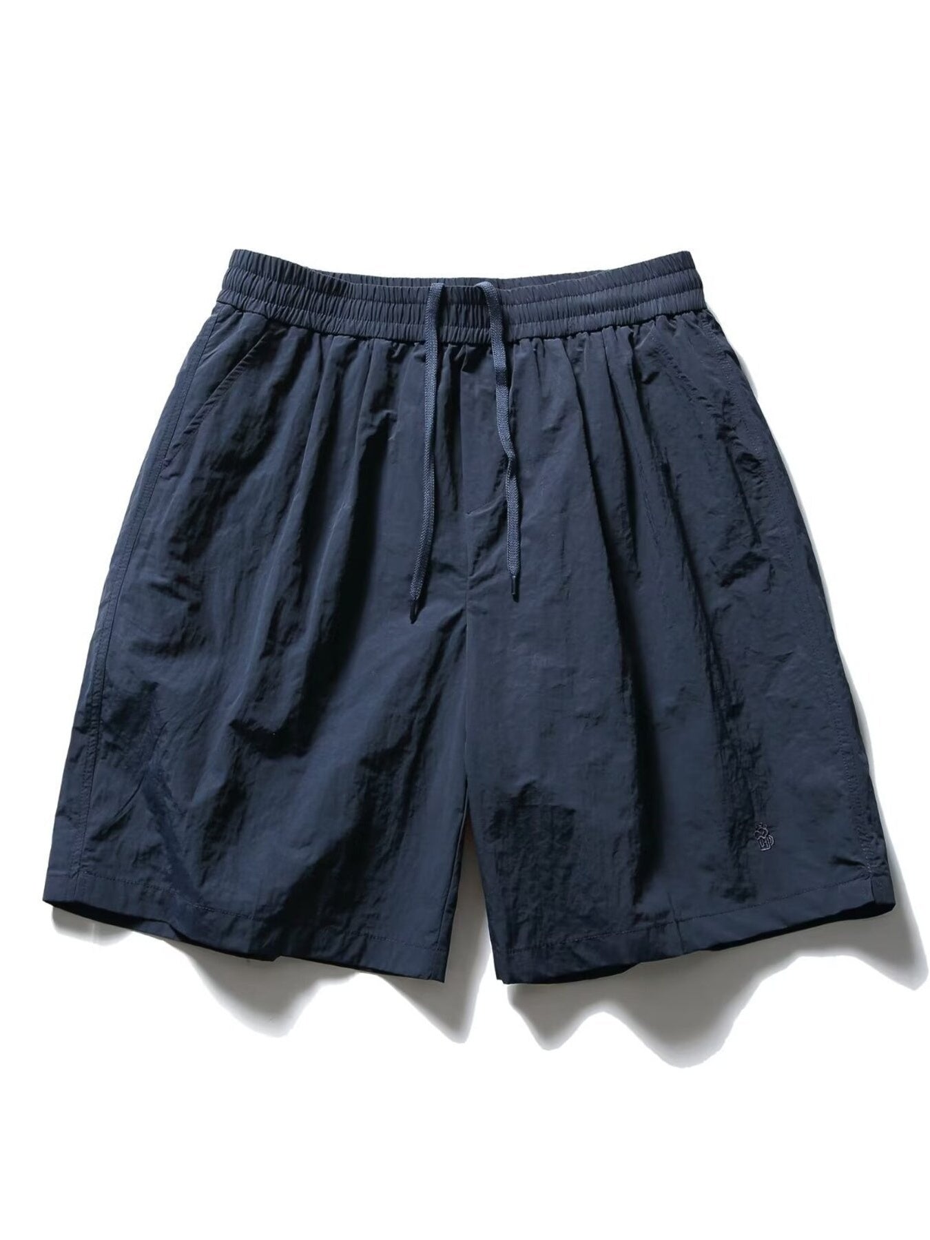 Men's navy blue textured drawstring shorts with elastic waistband and pockets.