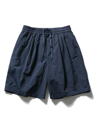 Men's navy blue textured drawstring shorts with elastic waistband and pockets.