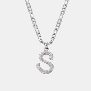 Silver initial pendant necklace with textured letter S on a figaro chain