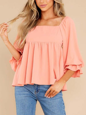 Watermelon pink babydoll blouse with square neckline, smocked back, and ruffled bell sleeves.