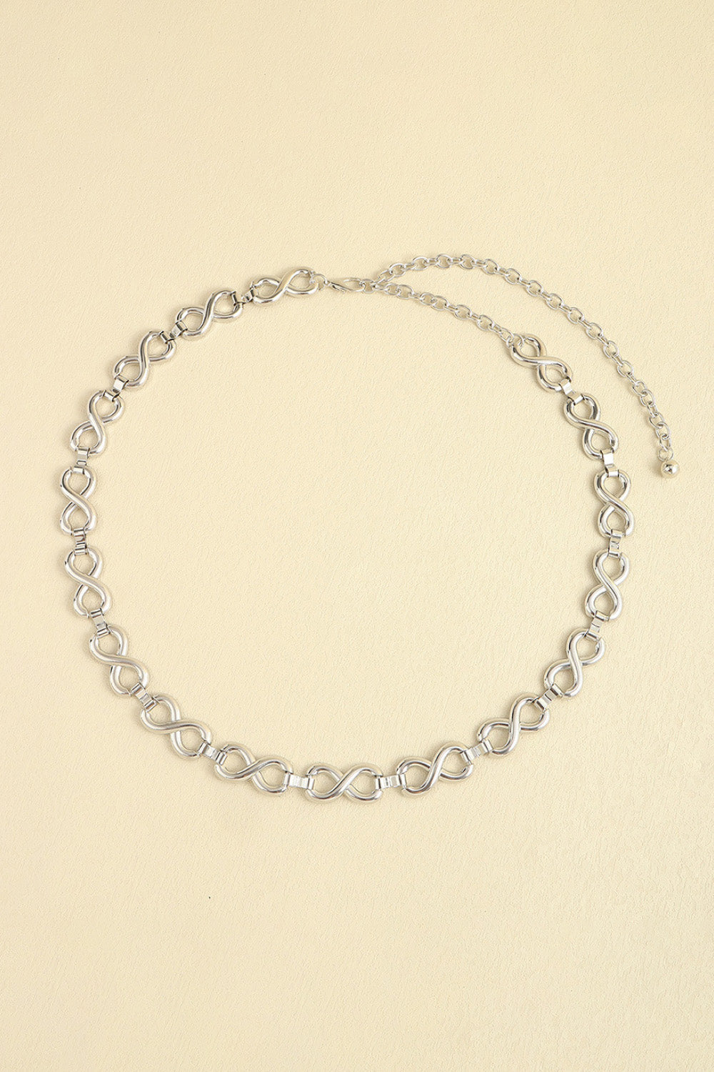 Silver infinity chain waist belt with adjustable extender.