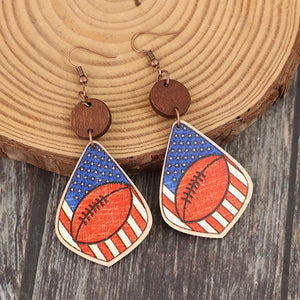 Patriotic football woodcut dangle earrings with American flag design.