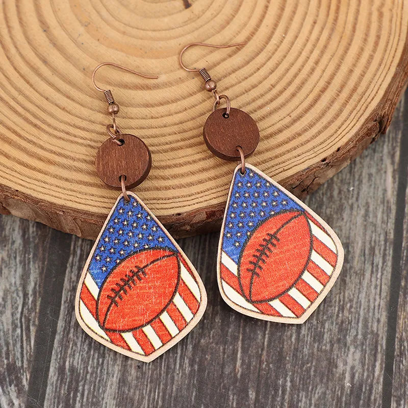 Patriotic football woodcut dangle earrings with American flag design.