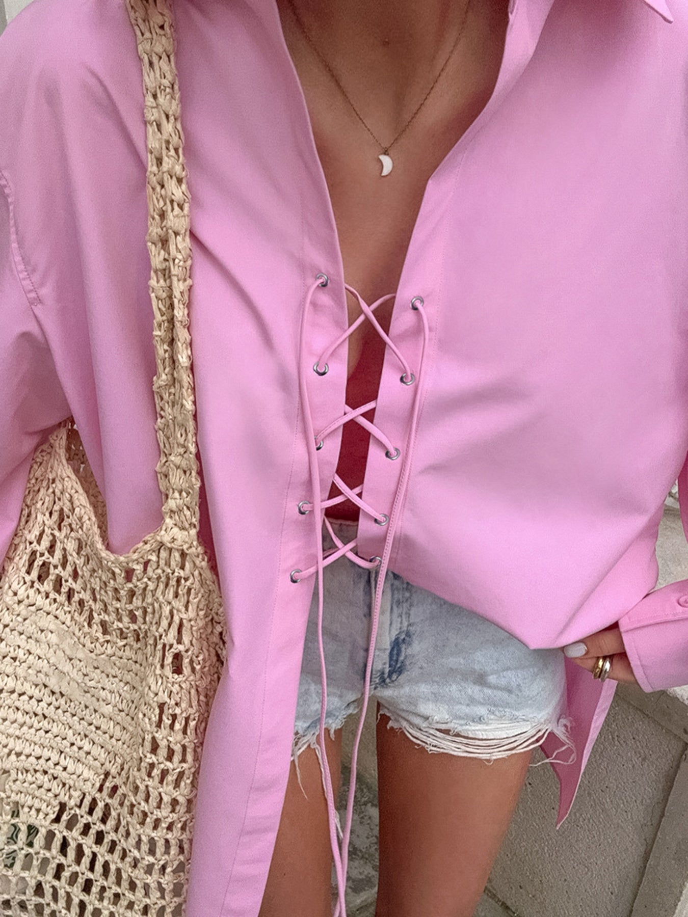 Pink cotton lace-up front relaxed fit shirt with a deep V-neckline.