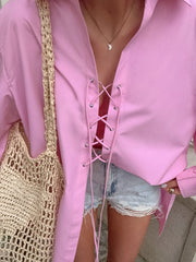 Pink cotton lace-up front relaxed fit shirt with a deep V-neckline.