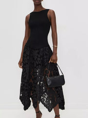 Black crochet midi dress with asymmetrical hem and cutout details, sleeveless ribbed bodice.
