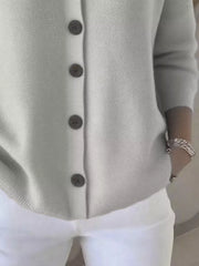 Gray button-front knit cardigan with a textured acrylic weave and dark buttons.