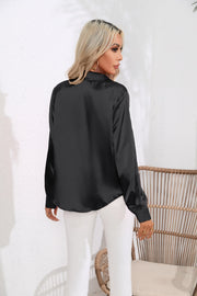 Black glossy satin button-down blouse with long sleeves.