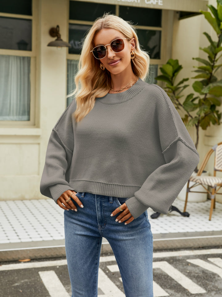 Dropped shoulder knit sweater in heather gray with balloon sleeves and crew neck.