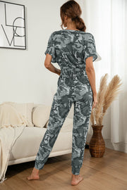 Gray camouflage print jumpsuit with short sleeves and elastic waist.