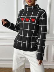 Black turtleneck sweater with white grid pattern and three red heart appliqués.