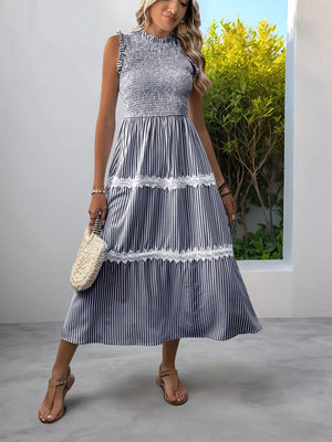 Navy blue striped midi dress with smocked bodice and lace trim.
