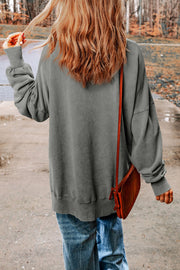 Oversized charcoal washed cotton sweatshirt with side slits and crew neck.