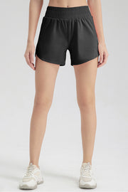 Black layered performance running shorts with elastic waistband and side vents.