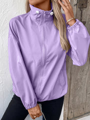 Lavender nylon bomber jacket with drawstring hem and full zip closure.