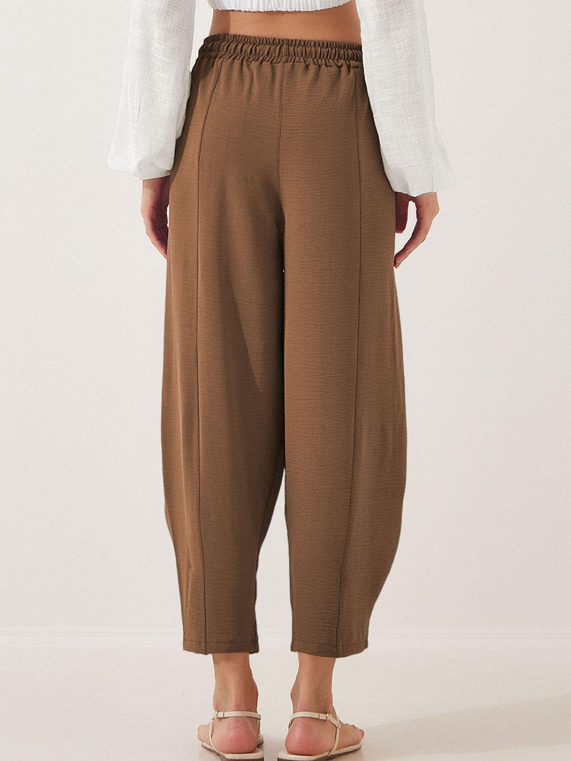 Brown balloon trousers with sculpted seamlines and elastic waist
