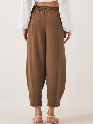 Brown balloon trousers with sculpted seamlines and elastic waist