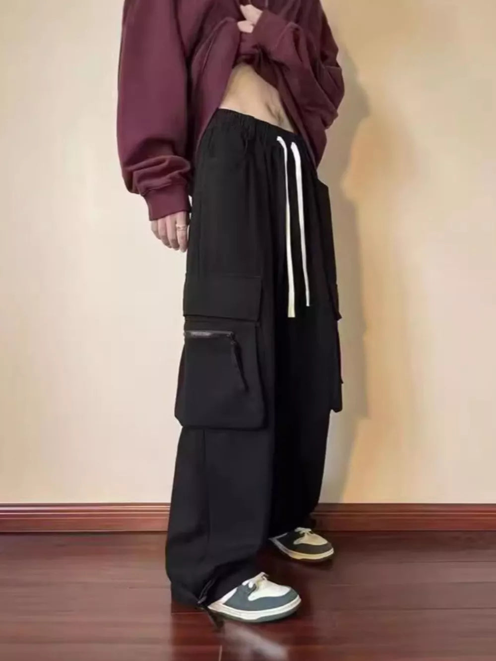 Black relaxed fit cargo sweatpants with drawstring and multi-pocket design.