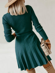 Ribbed knit wrap dress in army green with a pleated skirt and long sleeves.