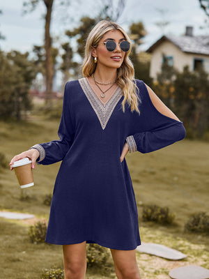 Navy cold shoulder mini dress with lace trim neckline and cuffs.
