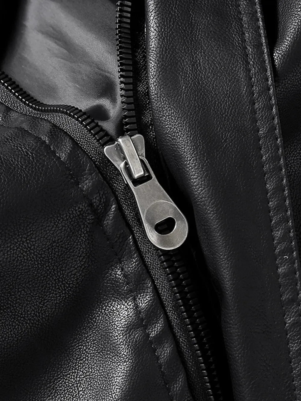 Black faux leather zip-up jacket detail with silver zipper pull.