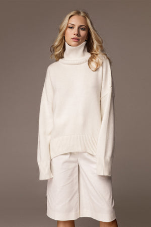 Oversized white cashmere turtleneck sweater with ribbed cuffs and hem.