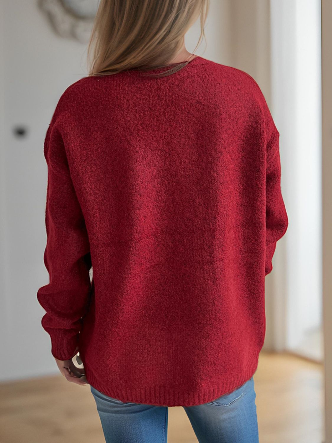 Burgundy knit sweater with crew neck and long sleeves, textured acrylic fabric.