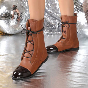 Brown leather ankle boots with glossy cap toes and black lace-up front.