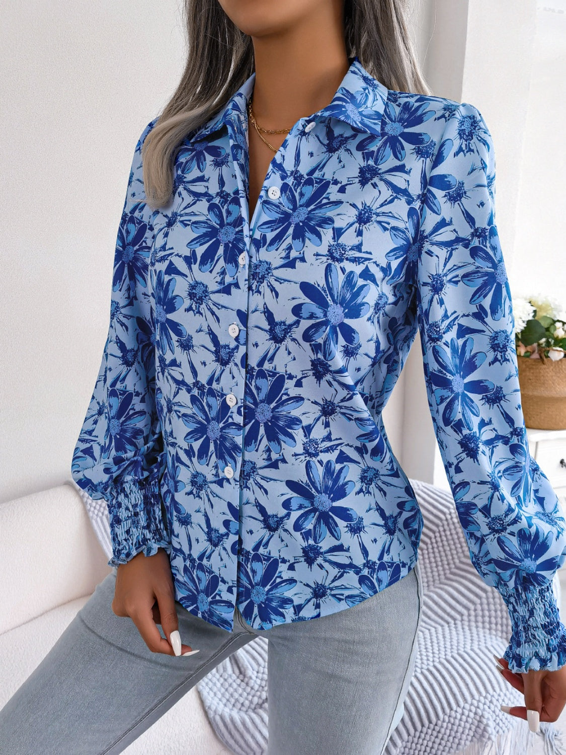 Royal blue floral print blouse with shirred cuffs and button front.