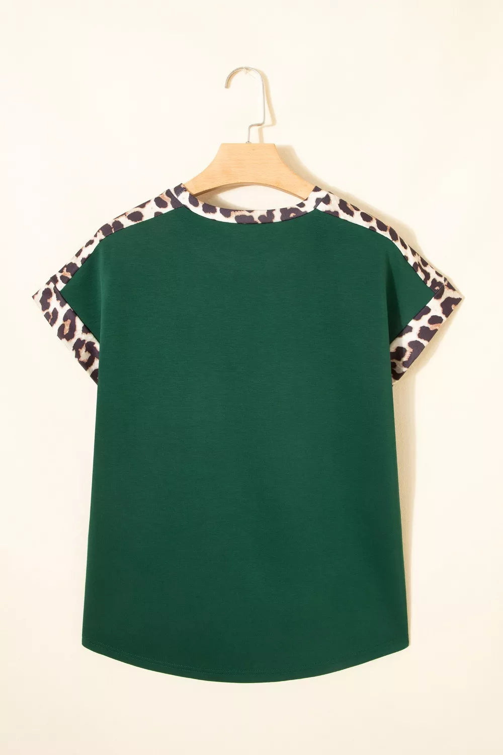 Green relaxed fit tee with leopard print trim on sleeves and neckline.