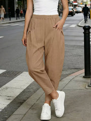 Camel harem pants with pockets and elastic waist, styled with white sneakers.