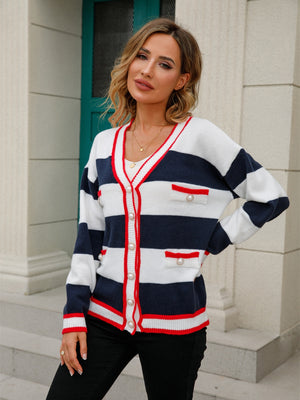 Navy and white striped knit cardigan with pearl buttons and red trim.