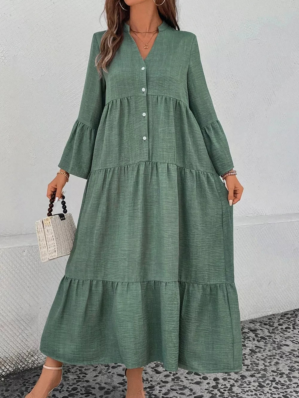 Green tiered ruffle hem v-neck dress with button front and bell sleeves.