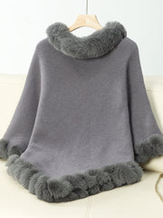 Dark gray knit poncho with faux fur trim at neckline and hem.