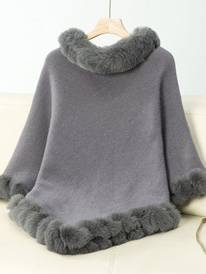 Dark gray knit poncho with faux fur trim at neckline and hem.