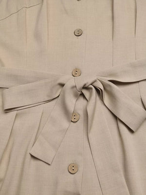 Beige V-neck romper with tie waist and button details