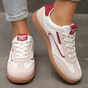 Cream and red lace-up sneakers with breathable mesh and suede accents.