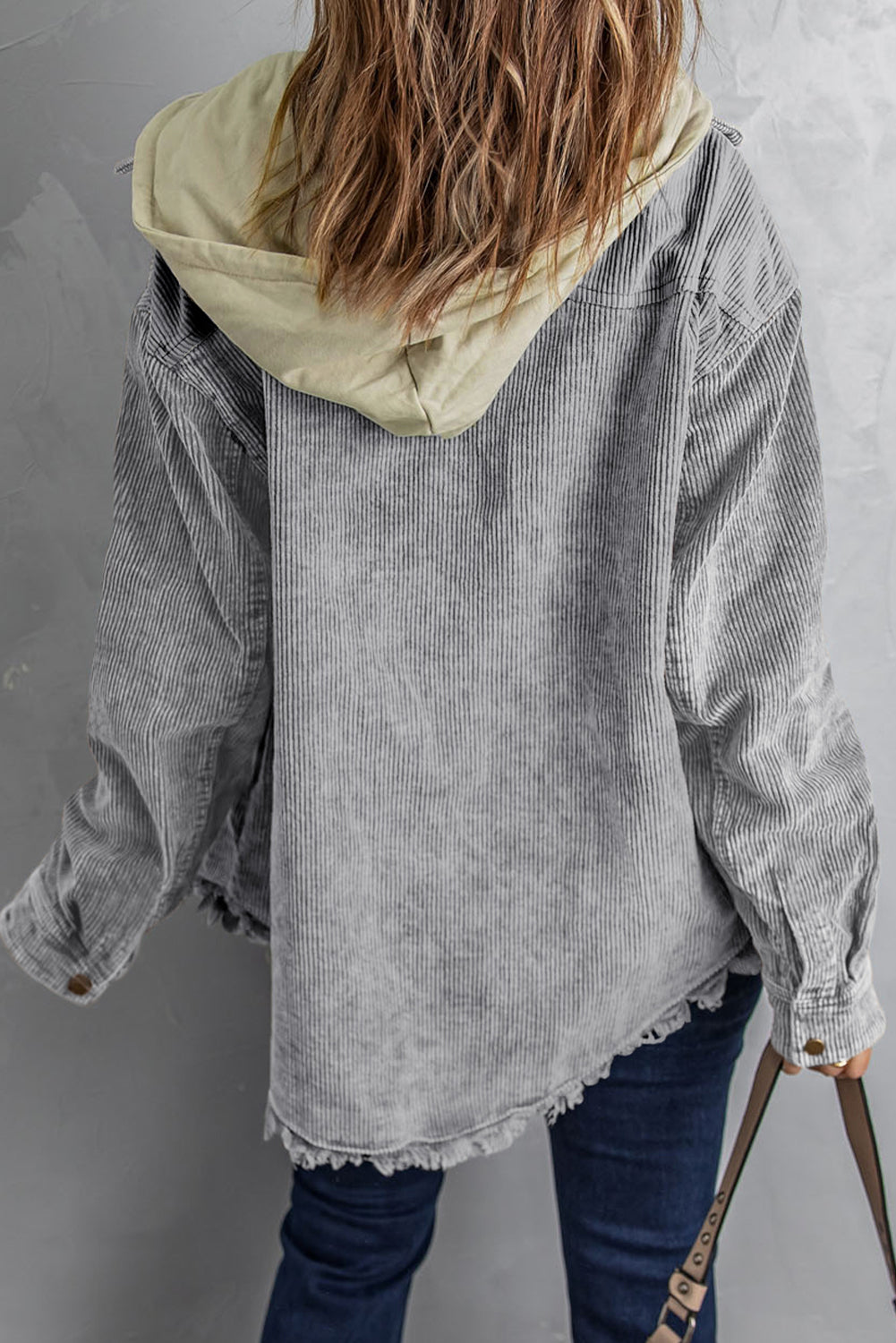 Gray corduroy hooded utility jacket with distressed hem and contrast hood.