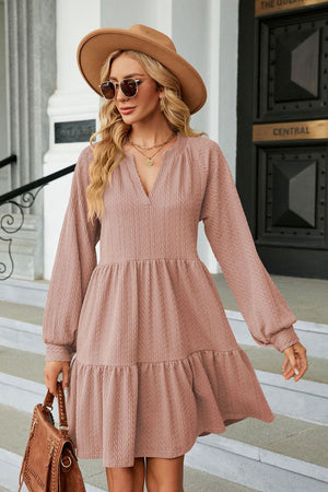 Textured babydoll mini dress in dusty pink with voluminous sleeves and tiered hem