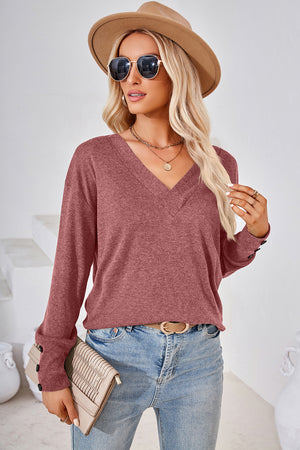 Button-cuff slouch v-neck top in Rust with long sleeves and a relaxed fit.