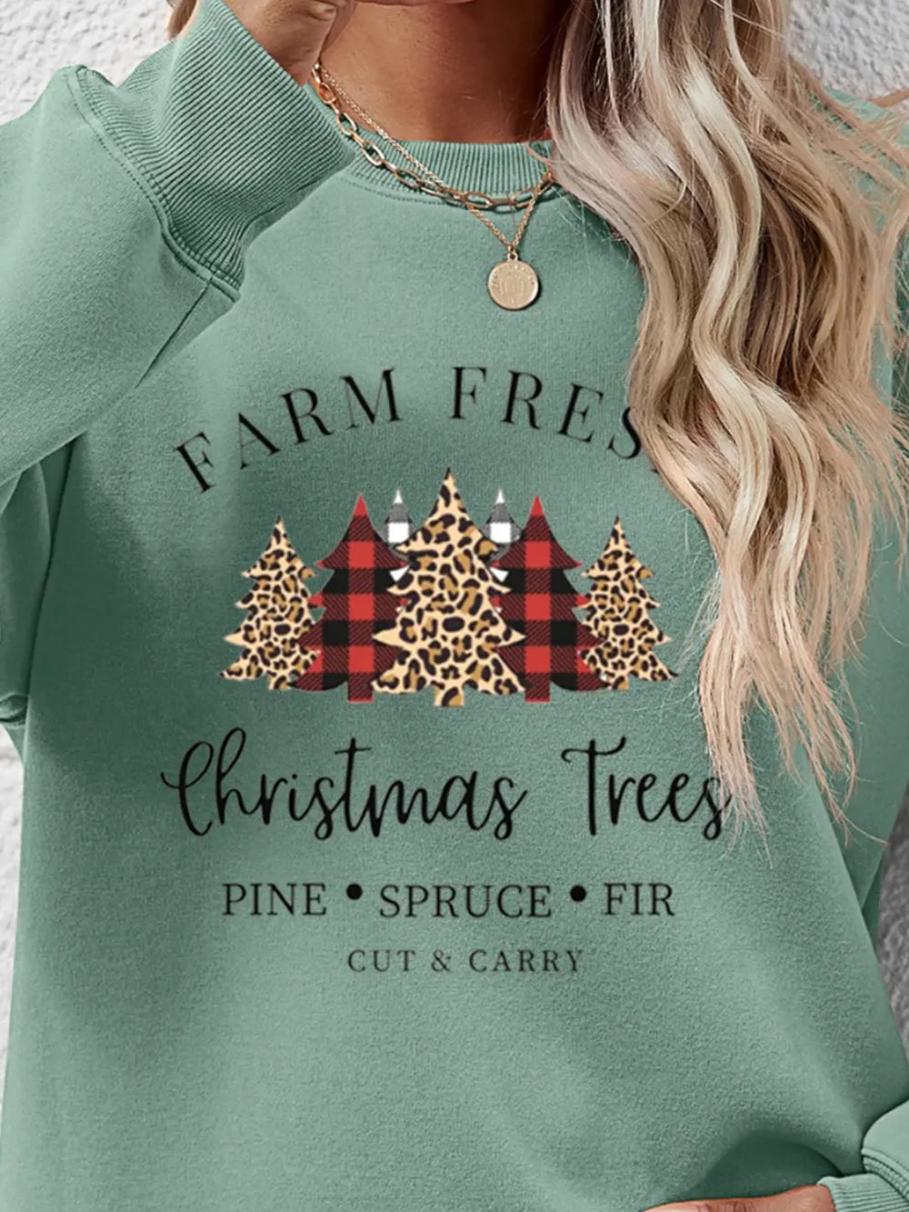 Crewneck sweatshirt in Sage green with Christmas trees graphic, buffalo plaid and leopard print detail.