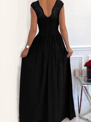 Black lace accent maxi dress with ruched bodice and flowing skirt.