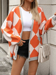 Orange and white argyle knit oversized cardigan with pockets and grey trim.