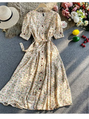 Floral V-neck midi dress in apricot with button front and belted waist.