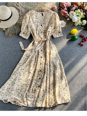 Floral V-neck midi dress in apricot with button front and belted waist.
