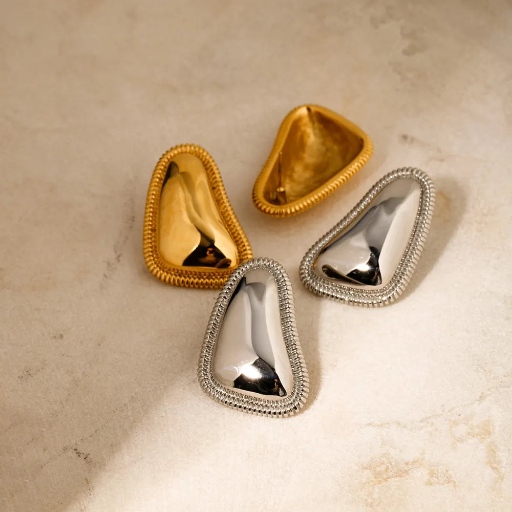 Sculpted gold vermeil earrings with textured trim in gold and silver finishes.