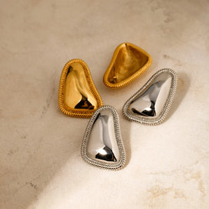 Sculpted gold vermeil earrings with textured trim in gold and silver finishes.