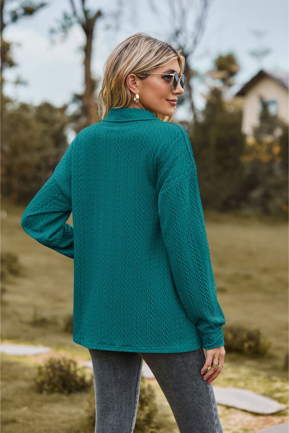 Textured knit polo shirt in turquoise with a collared neckline and long sleeves.